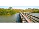 Scenic wooden walkway over water, connecting to a charming community with waterfront access at 14584 El Paseo Dr, Seminole, FL 33776