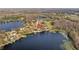 Breathtaking aerial view showcasing a home nestled between two pristine lakes surrounded by lush greenery at 19242 Blount Rd, Lutz, FL 33558