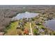 An aerial view of the property with a large lot, backing up to a lake at 19242 Blount Rd, Lutz, FL 33558