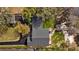 Aerial shot of the house shows roof, driveway, landscaping, backyard patio and lake access. Perfect for outdoor lifestyle at 19242 Blount Rd, Lutz, FL 33558