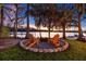 Relax by the lakeside fire pit surrounded by mature trees, with comfortable Adirondack chairs to enjoy the sunset views at 19242 Blount Rd, Lutz, FL 33558