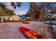 Expansive waterfront backyard with kayaks, lounge chairs and beach umbrellas at 19242 Blount Rd, Lutz, FL 33558