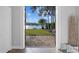 Doorway view of a beautiful backyard with lush greenery and lake view at 19242 Blount Rd, Lutz, FL 33558