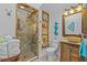 Charming bathroom features a walk-in shower with elegant fixtures, a rustic vanity, and stylish decor at 19242 Blount Rd, Lutz, FL 33558