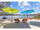 Sandy beach featuring a jet ski, kayak, and chairs with umbrellas overlooking the lake at 19242 Blount Rd, Lutz, FL 33558