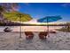 Beautiful sandy beach with seating, umbrellas, watercraft and lake at sunset create a relaxing outdoor living space at 19242 Blount Rd, Lutz, FL 33558