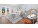 Bright bedroom featuring a sitting area, serene decor, and double glass doors to allow for plenty of natural light at 19242 Blount Rd, Lutz, FL 33558
