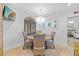 Inviting dining area features a round table with seating for four, stylish light fixture and views of the outdoor scenery at 19242 Blount Rd, Lutz, FL 33558