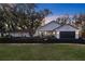 Charming single-story home boasts meticulous landscaping and a circular driveway, exuding curb appeal at 19242 Blount Rd, Lutz, FL 33558