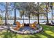 Inviting lakeside fire pit featuring Adirondack chairs, perfect for enjoying serene outdoor evenings at 19242 Blount Rd, Lutz, FL 33558
