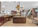 Spacious kitchen boasts a large island, stainless steel appliances, ample cabinet space, and views of staircase and dining area at 19242 Blount Rd, Lutz, FL 33558