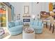 Cozy living room featuring comfortable chairs, modern fireplace and travertine flooring at 19242 Blount Rd, Lutz, FL 33558
