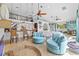 Open-concept living room with vaulted ceilings, a loft, tile floors, large windows, and stylish, comfortable furnishings at 19242 Blount Rd, Lutz, FL 33558