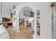Bright, open living area showcasing tile floors, archways and smooth transition to kitchen at 19242 Blount Rd, Lutz, FL 33558