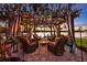 Inviting lake-front patio with pergola, outdoor seating, a fire pit and ambient lighting, ideal for entertaining at 19242 Blount Rd, Lutz, FL 33558