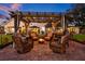 Beautiful backyard patio with pergola, fire pit, outdoor seating and landscaped yard; perfect for entertaining at 19242 Blount Rd, Lutz, FL 33558