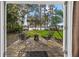 Enjoy this peaceful outdoor patio with a lovely view of the expansive backyard, mature trees, and serene lake at 19242 Blount Rd, Lutz, FL 33558
