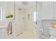 Updated shower featuring glass doors, white tile, a built-in bench, and storage nook at 19242 Blount Rd, Lutz, FL 33558