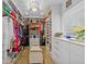 Spacious walk-in closet with custom shelving, drawers, and bench at 19242 Blount Rd, Lutz, FL 33558