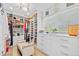 This large walk-in closet boasts ample shelving, drawer space, and a comfortable seating area with natural light at 19242 Blount Rd, Lutz, FL 33558
