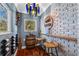 Charming wine cellar featuring brick accents, bottle storage, unique light fixture and a cozy barrel table with stools at 19242 Blount Rd, Lutz, FL 33558