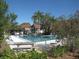 Community pool featuring lounge chairs surrounded by trees and tropical plants at 200 N Bayshore Blvd # 105, Clearwater, FL 33759