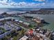 Stunning aerial view showcasing waterfront property near the ocean, featuring a nearby marina and bridge at 227 126Th Ave, Treasure Island, FL 33706