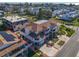 An aerial view shows a large, multi-story home with a driveway and screened balconies, near the beach at 227 126Th Ave, Treasure Island, FL 33706