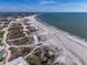 Aerial shot of the sandy beach and the ocean at the horizon at 227 126Th Ave, Treasure Island, FL 33706