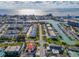 Picturesque aerial view showing the property's location along the water, with nearby townhouses and a marina at 227 126Th Ave, Treasure Island, FL 33706