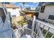 Cozy fenced backyard features spiral staircase, brick-paved patio with table and chairs, plus green landscaping at 227 126Th Ave, Treasure Island, FL 33706