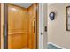 Interior view of a residential elevator featuring wood paneled walls and a control panel at 227 126Th Ave, Treasure Island, FL 33706