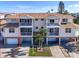 The exterior of the home shows screened balconies, garage spaces, and nicely kept landscaping at 227 126Th Ave, Treasure Island, FL 33706