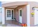 The home's front porch shows tile flooring, columns, two exterior doors, and colorful flower arrangements at 227 126Th Ave, Treasure Island, FL 33706