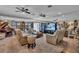 The living room features a large seating area, multiple clocks, and a beautiful upright piano at 227 126Th Ave, Treasure Island, FL 33706