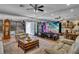 The living room has multiple seating options, a large entertainment center and tiled floors at 227 126Th Ave, Treasure Island, FL 33706