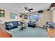 Living room with plush furniture, ceiling fan, and window offering views of the neighborhood at 227 126Th Ave, Treasure Island, FL 33706