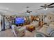 The living room is spacious and includes leather furniture, a large television, and tiled floors at 227 126Th Ave, Treasure Island, FL 33706