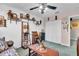 Cozy room featuring eclectic decor, ceiling fan, sofa, and built-in storage shelves for a unique living space at 227 126Th Ave, Treasure Island, FL 33706