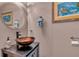 Stylish powder room with a decorative bowl sink and modern fixtures at 227 126Th Ave, Treasure Island, FL 33706