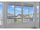 Bright sun room boasting multiple windows with views of the neighborhood, boats, and palm trees at 227 126Th Ave, Treasure Island, FL 33706