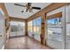 Well-lit sunroom with tile flooring, windows overlooking a patio area, and a door leading to the outdoors at 227 126Th Ave, Treasure Island, FL 33706