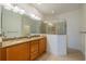 Primary bathroom featuring double sinks with granite counters, wood cabinets and walk-in shower at 2313 Nottingham Greens Dr # 2313, Sun City Center, FL 33573