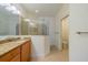 Modern bathroom features granite vanity top, glass enclosed shower, and tiled floors for a clean look at 2313 Nottingham Greens Dr # 2313, Sun City Center, FL 33573