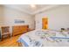 Light-filled bedroom with hardwood floors, tray ceiling, and a comfortable bed with a floral quilt at 2313 Nottingham Greens Dr # 2313, Sun City Center, FL 33573