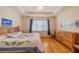 Spacious bedroom with hardwood floors, tray ceiling, and large window providing natural light at 2313 Nottingham Greens Dr # 2313, Sun City Center, FL 33573