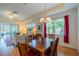 Open concept living and dining area with natural light, chandelier, and access to a screened lanai at 2313 Nottingham Greens Dr # 2313, Sun City Center, FL 33573