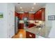 Kitchen featuring granite countertops, stainless steel appliances, and ample dark wood cabinet space at 2313 Nottingham Greens Dr # 2313, Sun City Center, FL 33573