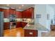 Well-equipped kitchen featuring granite countertops, stainless steel appliances, and dark wood cabinetry at 2313 Nottingham Greens Dr # 2313, Sun City Center, FL 33573
