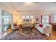 Cozy living room featuring hardwood floors, comfortable seating, and sliding glass doors with views of the outdoors at 2313 Nottingham Greens Dr # 2313, Sun City Center, FL 33573